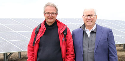 Commissioner Jean-Jacques Yarmoff and General Manager, Joseph Kowalik standing in front of solar site